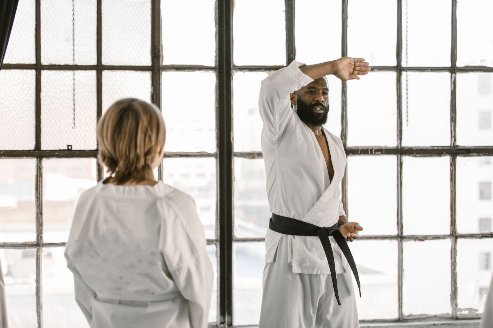 Diverse group of martial arts instructors in a studio training together