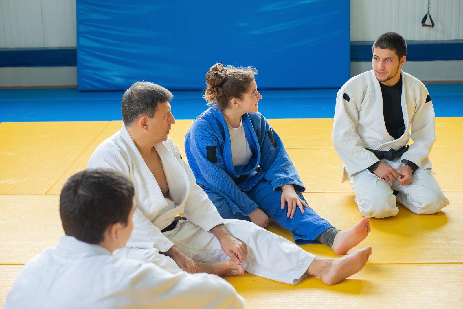 group of martial artists in training stance during a structured class