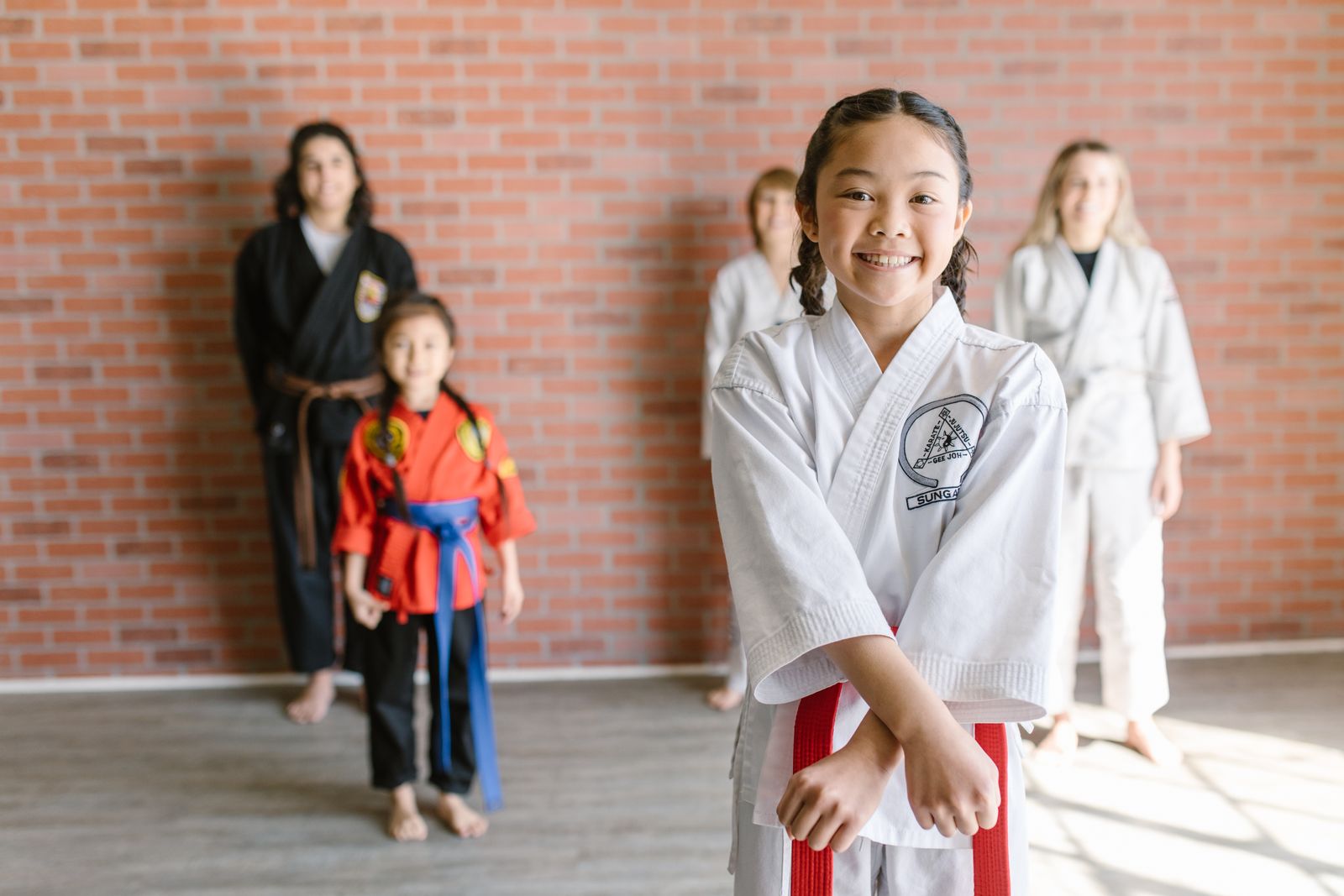 young student performing a martial arts kick with focus and power